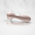 Pink electronic device on a reflective surface with a light gray background